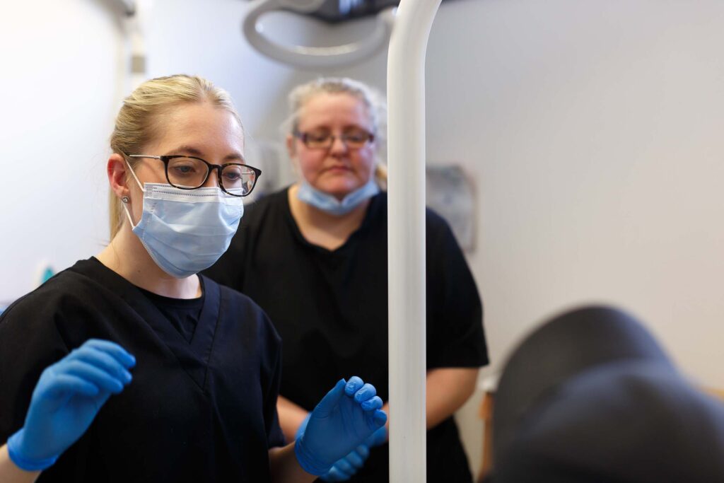 Dr. Charlotte Lingard and Andrea Winterbottom in the treatment room, dealing with a patient, Skipton Road Dental, Colne